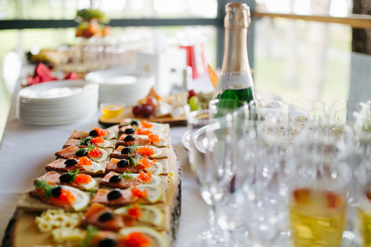 creative-02 Platter of gourmet appetizers served with champagne for a stylish event.