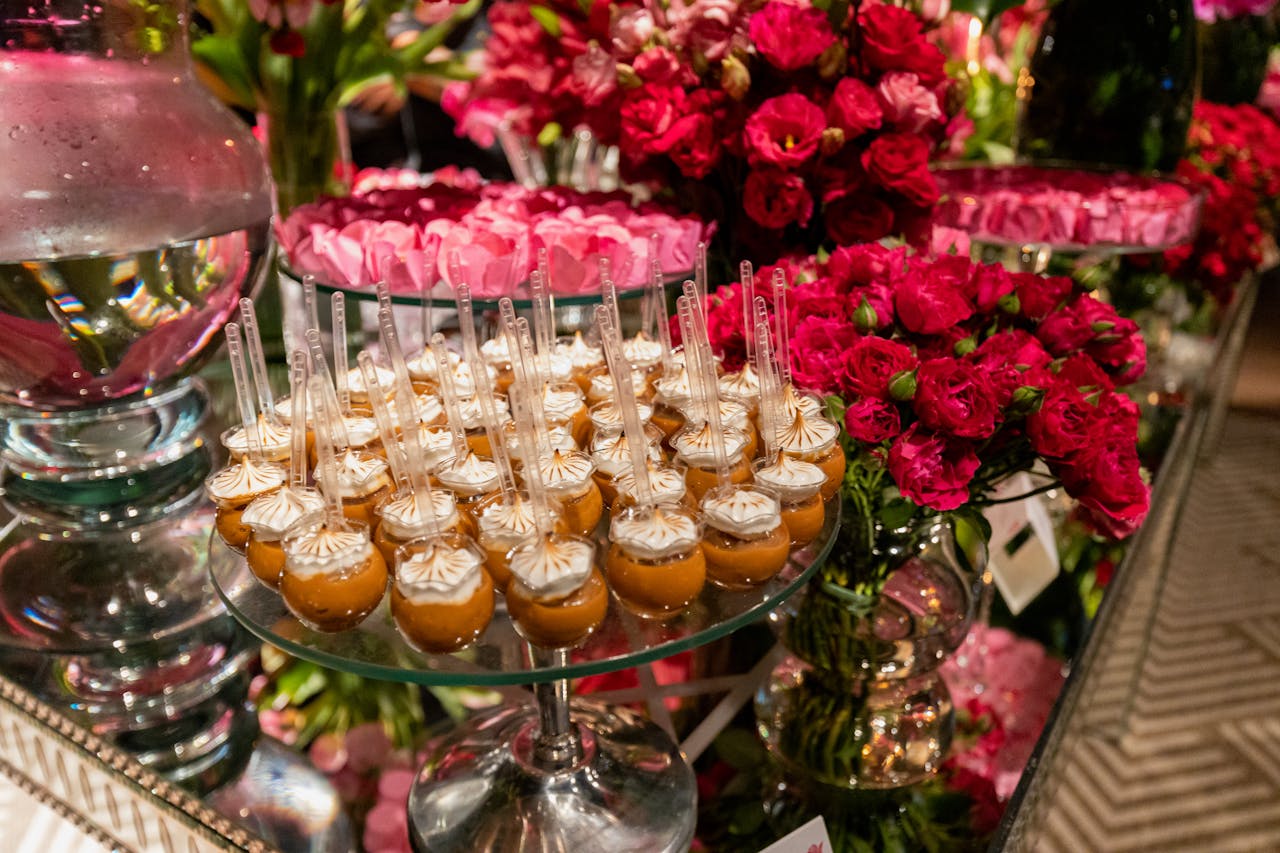 creative-03 Gourmet desserts and vibrant floral decor at a luxurious wedding reception.