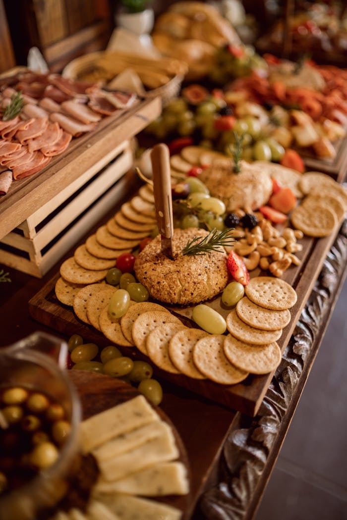 creative-01 A beautifully arranged grazing table featuring cheeses, cold meats, fruits, and crackers.