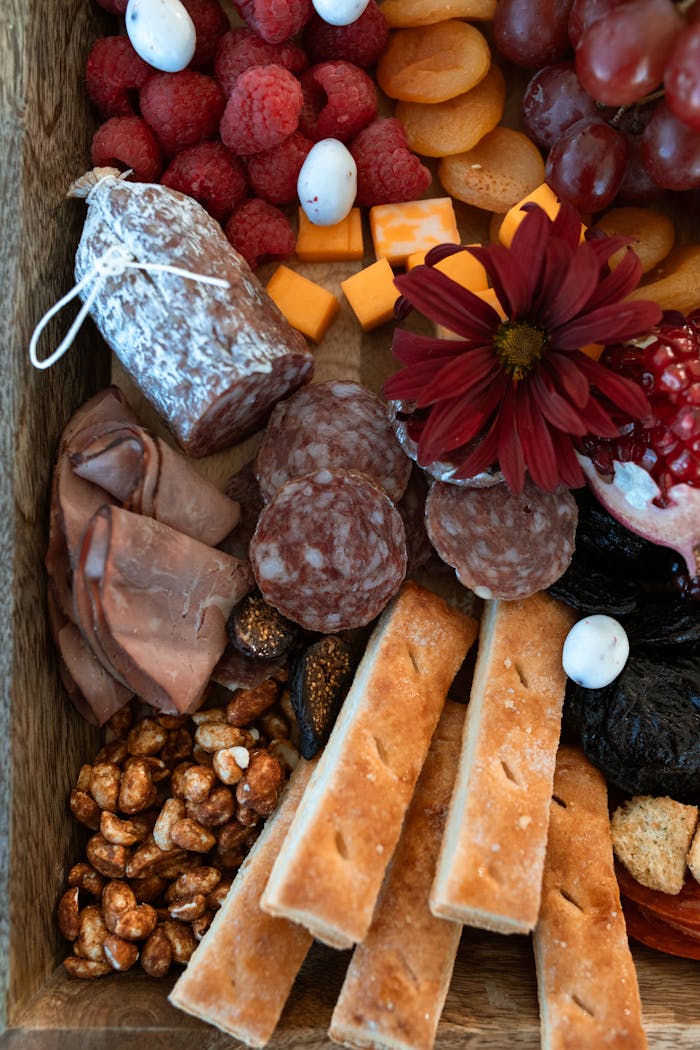 creative-03 A rustic charcuterie board featuring cured meats, cheeses, nuts, and fresh fruits, perfect for food lovers.